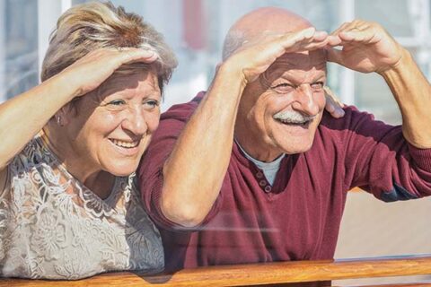 Happy senior couple having fun looking to future - Concept of ac