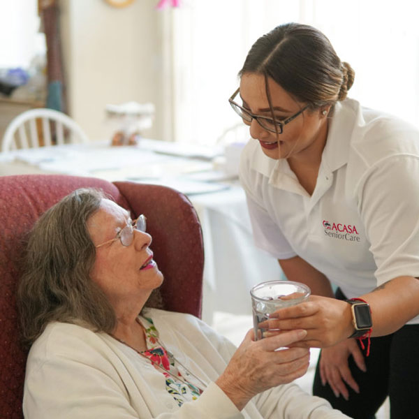 nurse giving patient drink